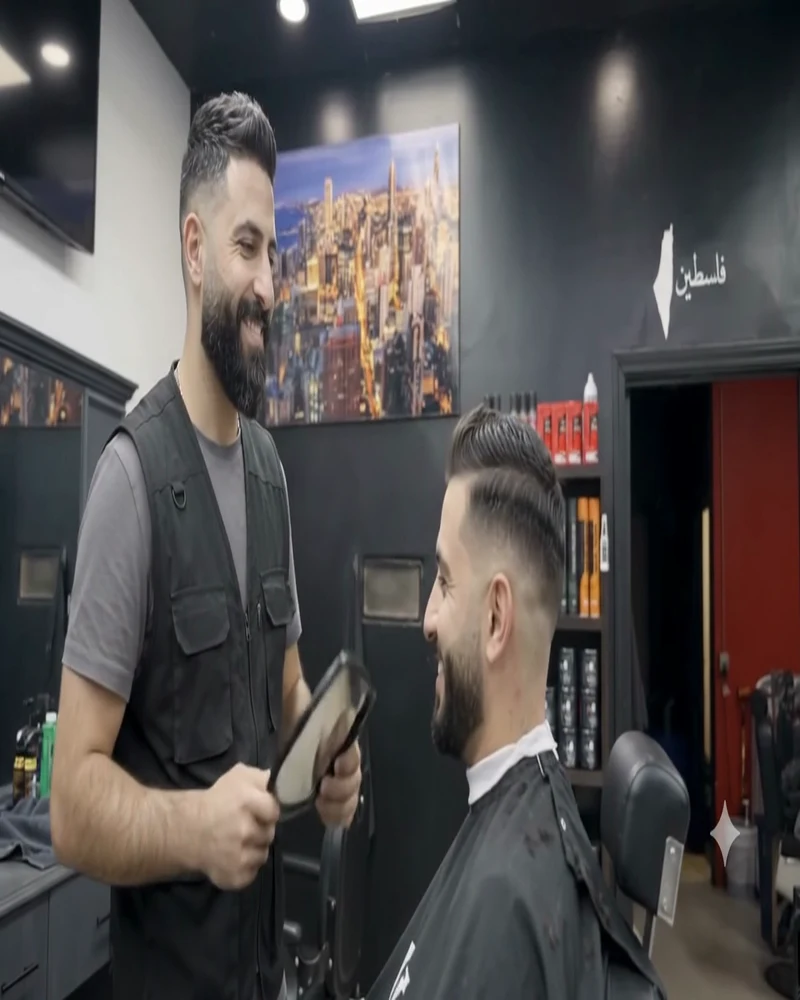 Barber holding the mirror to show the finished cut