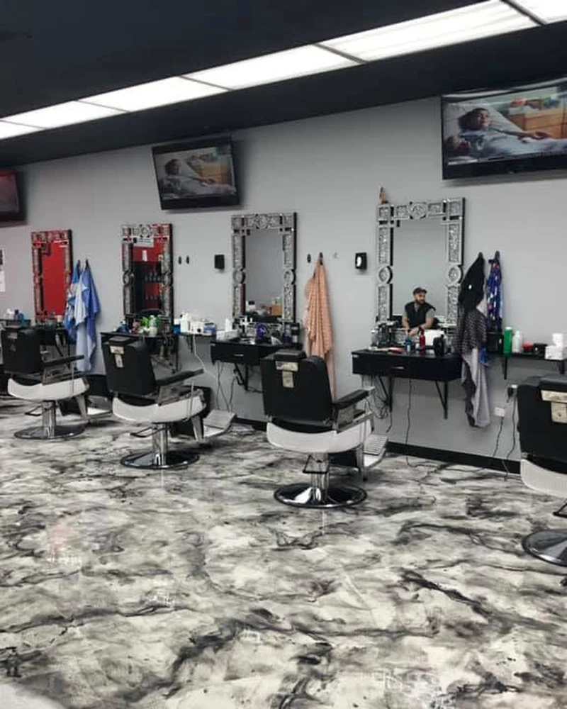 Inside the Xtreme Cuts shop — chairs, mirrors, and marble floor
